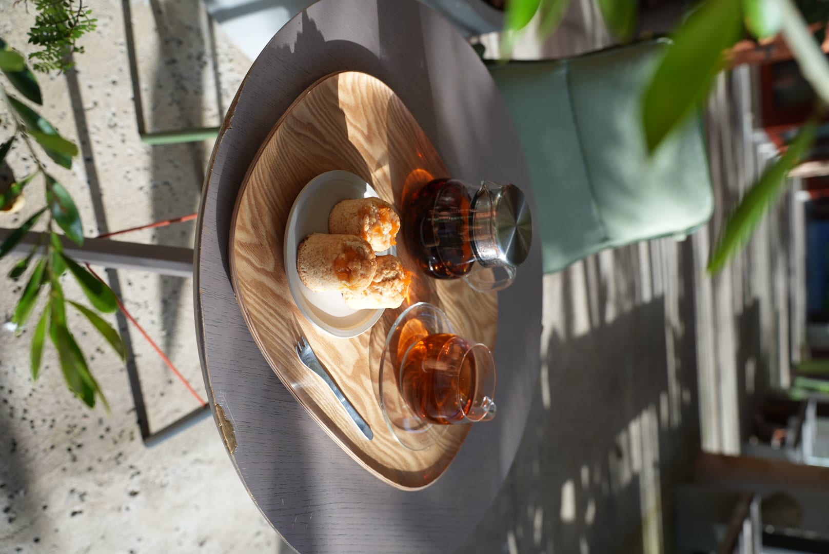 A tray of fresh pastries and iced drinks on a terrazzo table